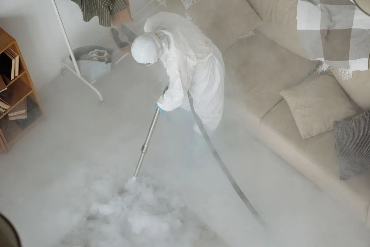 Biohazard cleanup technician in protective equipment, University Terrace, Dallas, TX